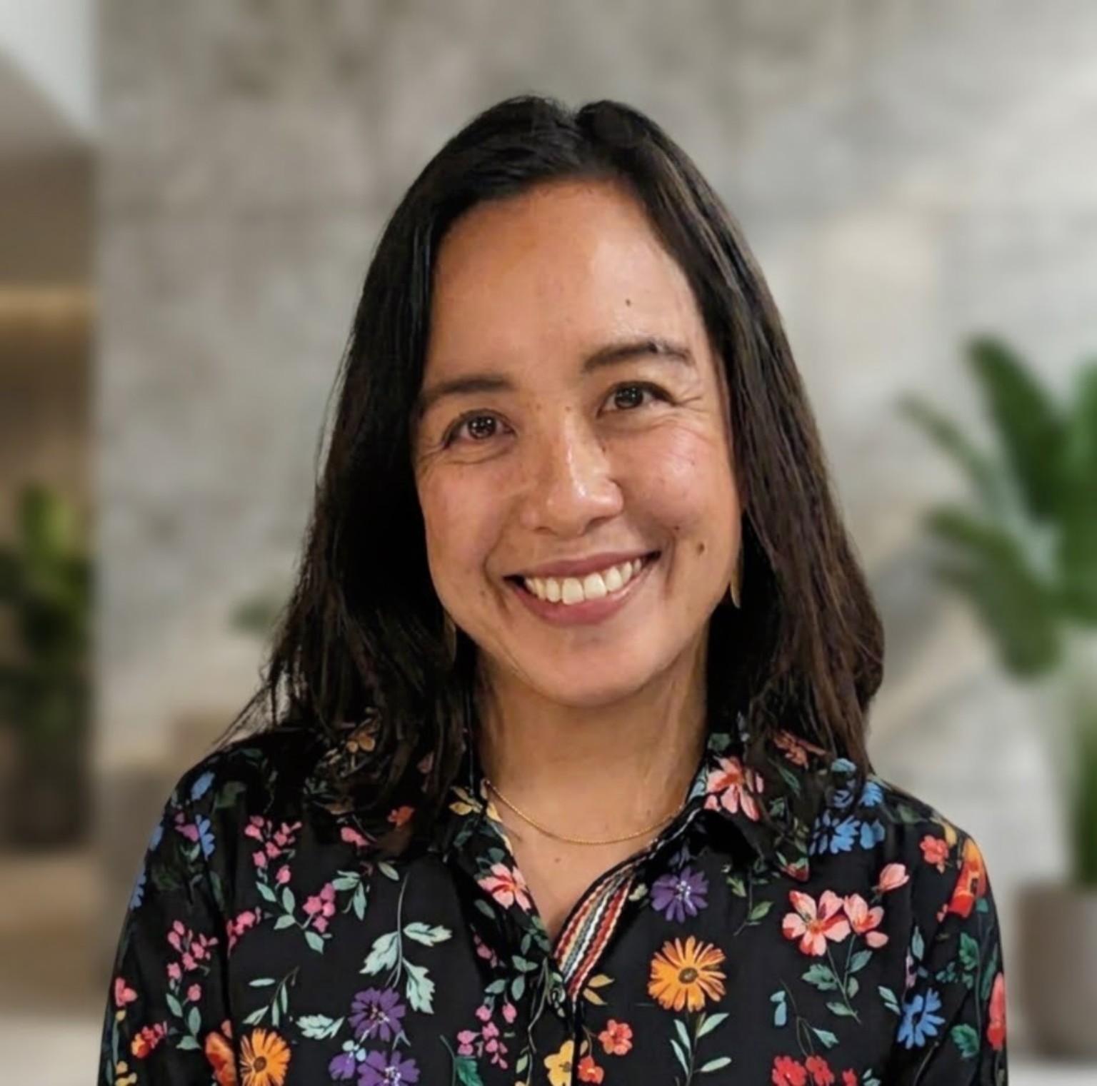 Karla Gregorio smiling in a floral blouse